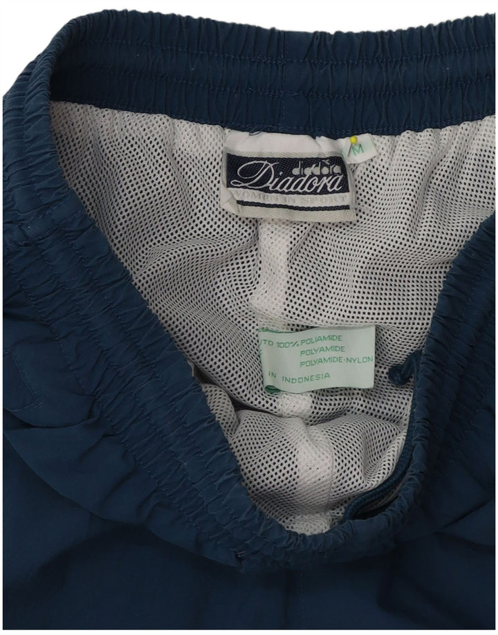 Мужские спортивные брюки Diadora из полиэстера среднего синего цвета