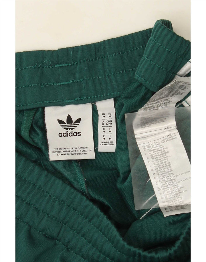 Мужские спортивные брюки Adidas среднего размера из полиэстера зеленого цвета